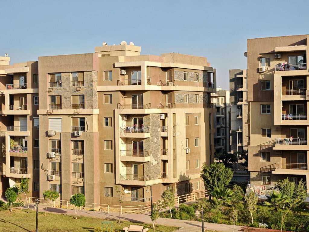 pexels photo 34365486 34365486 A modern apartment complex with multiple buildings in a sunny urban environment, showcasing contemporary architecture.