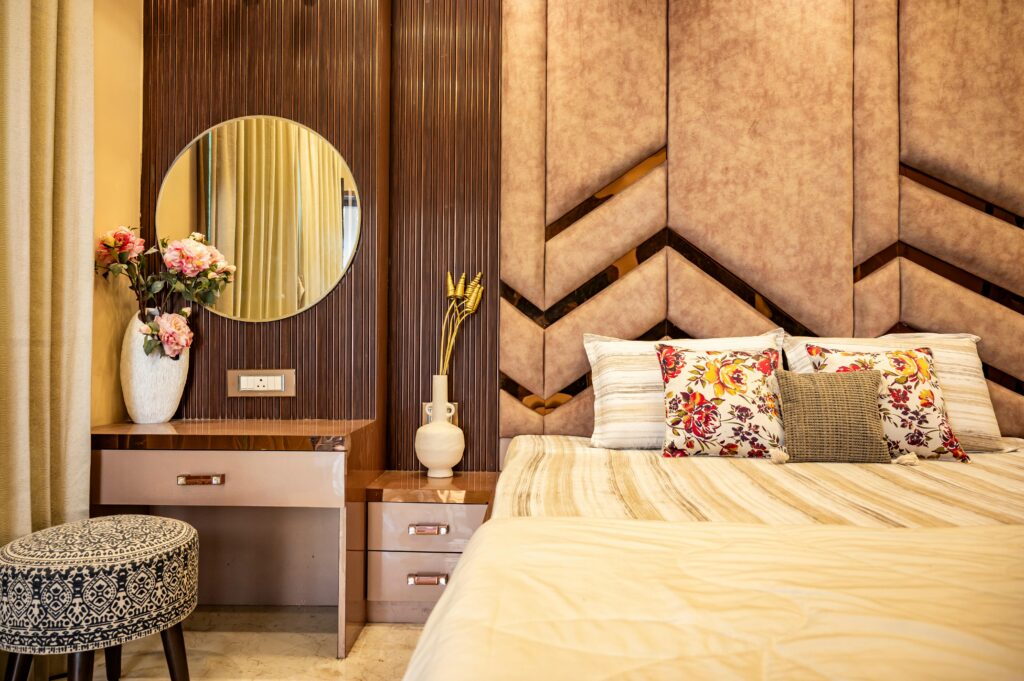 pexels photo 36601411 36601411 Stylish bedroom interior featuring a cozy bed, floral pillows, and a chic vanity setup.