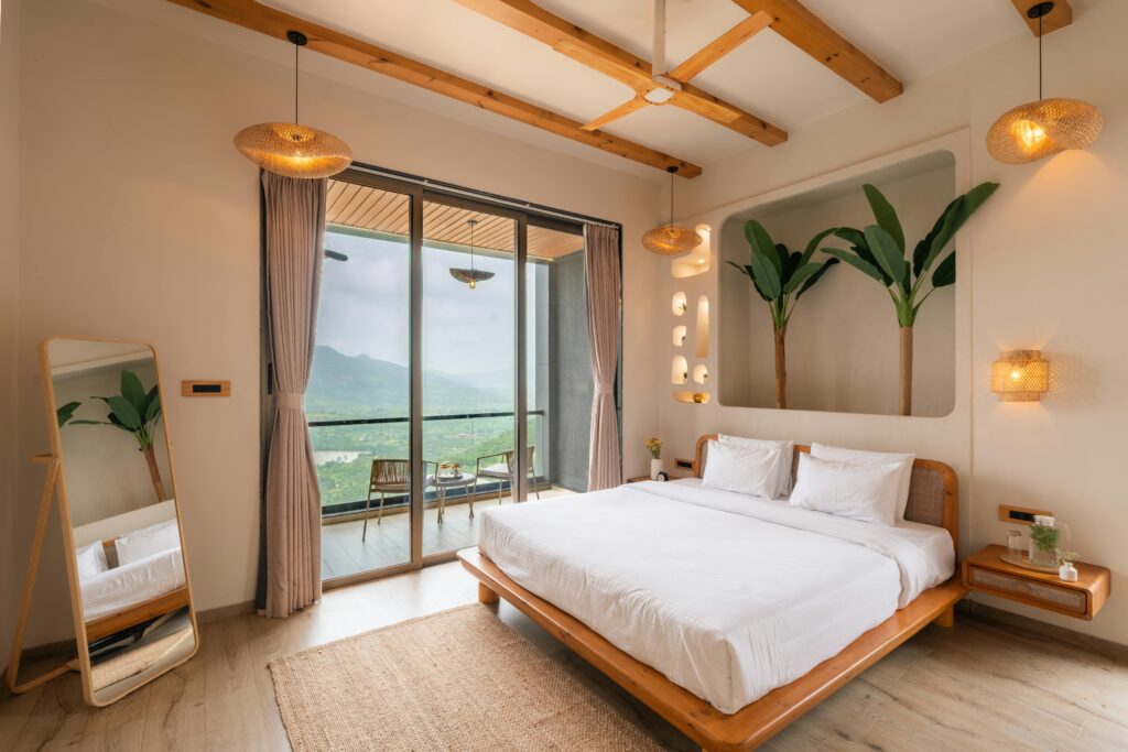 pexels photo 36710323 36710323 Elegant bedroom with modern decor and a stunning mountain vista through large glass doors.