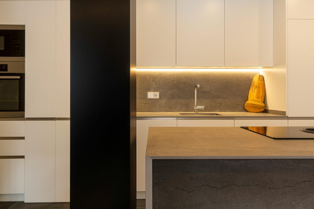 pexels photo 7852025 7852025 A stylish kitchen featuring modern design with minimalist elements and warm lighting.